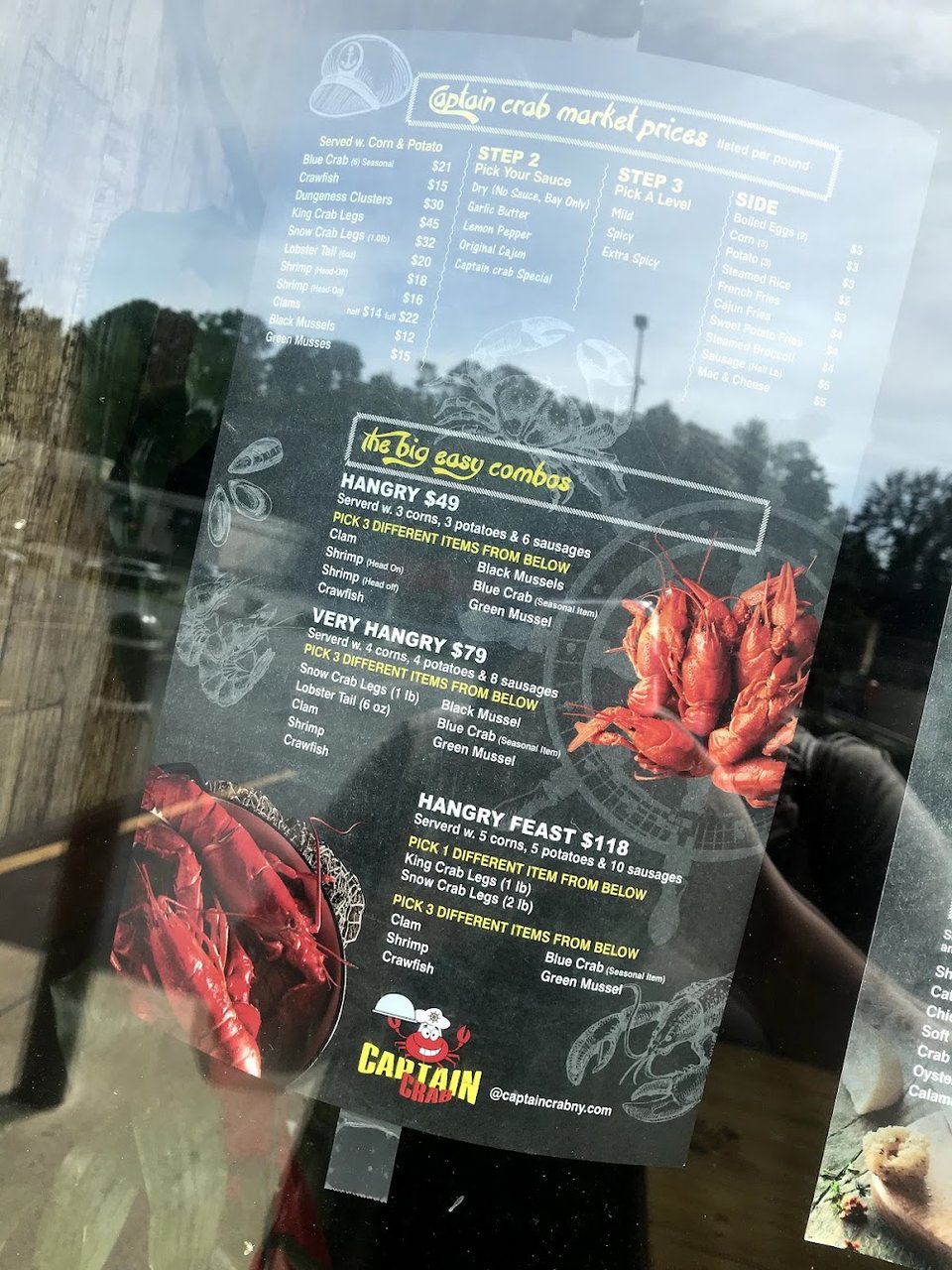 Printed menu beside seafood dishes.